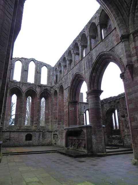 The roofless presbytery of Lanercost Priory with three tiers of arches and lancet windows