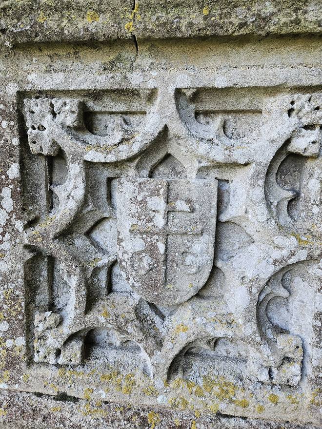 A carved stone shield with Thomas Spring's merchant's mark on the outside wall of Lavenham church