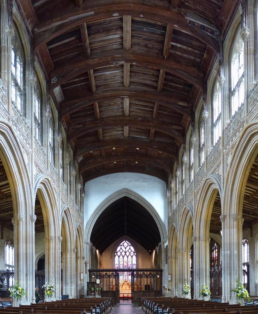 The tall nave of Lavenham church with slender piers, clerestory windows and a carved timber roof