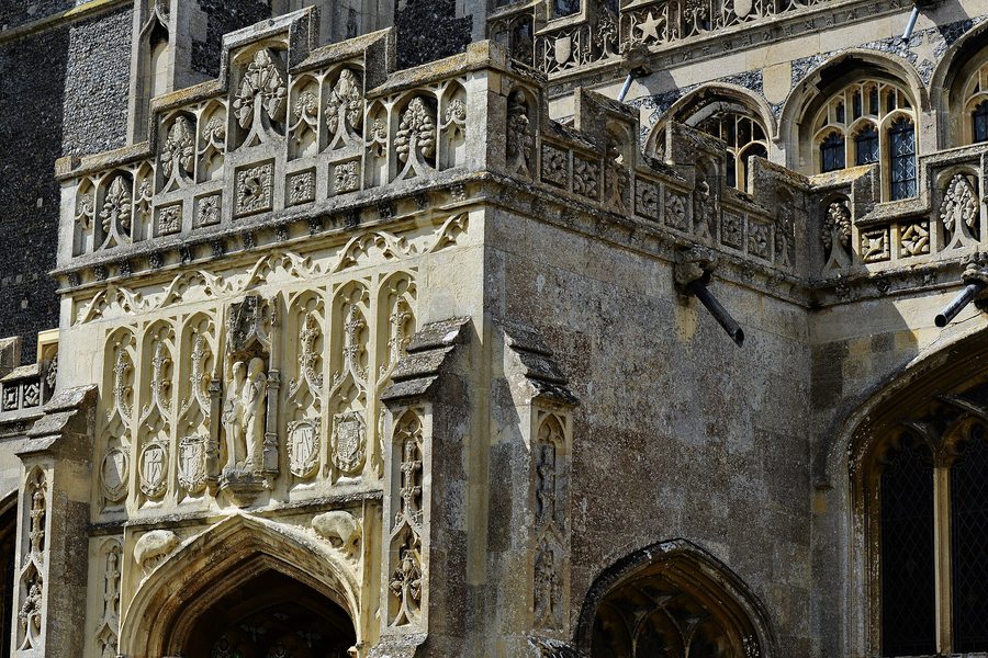 The south porch of Lavenham church, decorated with carved stone panels and coats of arms