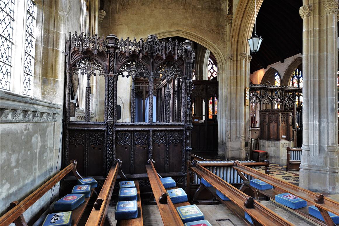 The richly carved wooden parclose screen around the Spring family chantry in Lavenham church