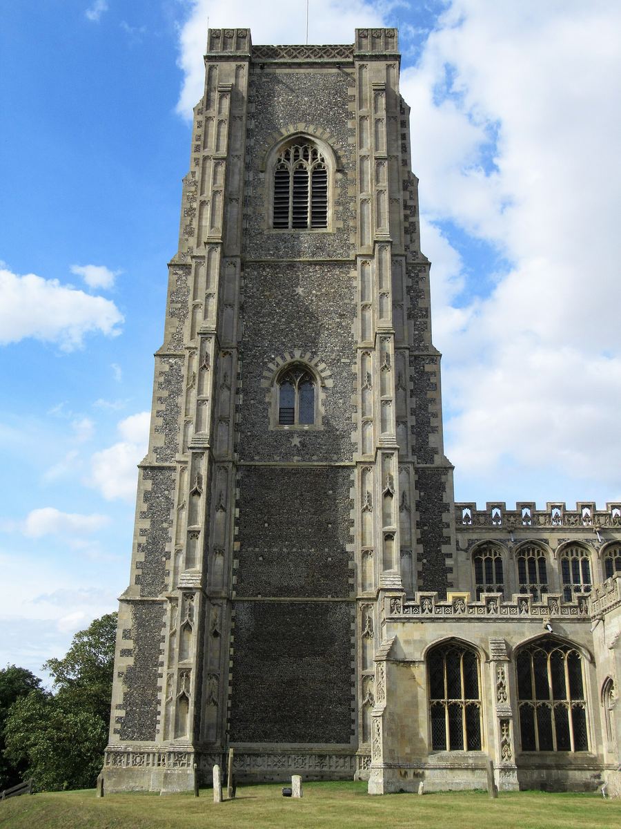 The tall flint and stone tower of Lavenham church with its buttresses and battlements