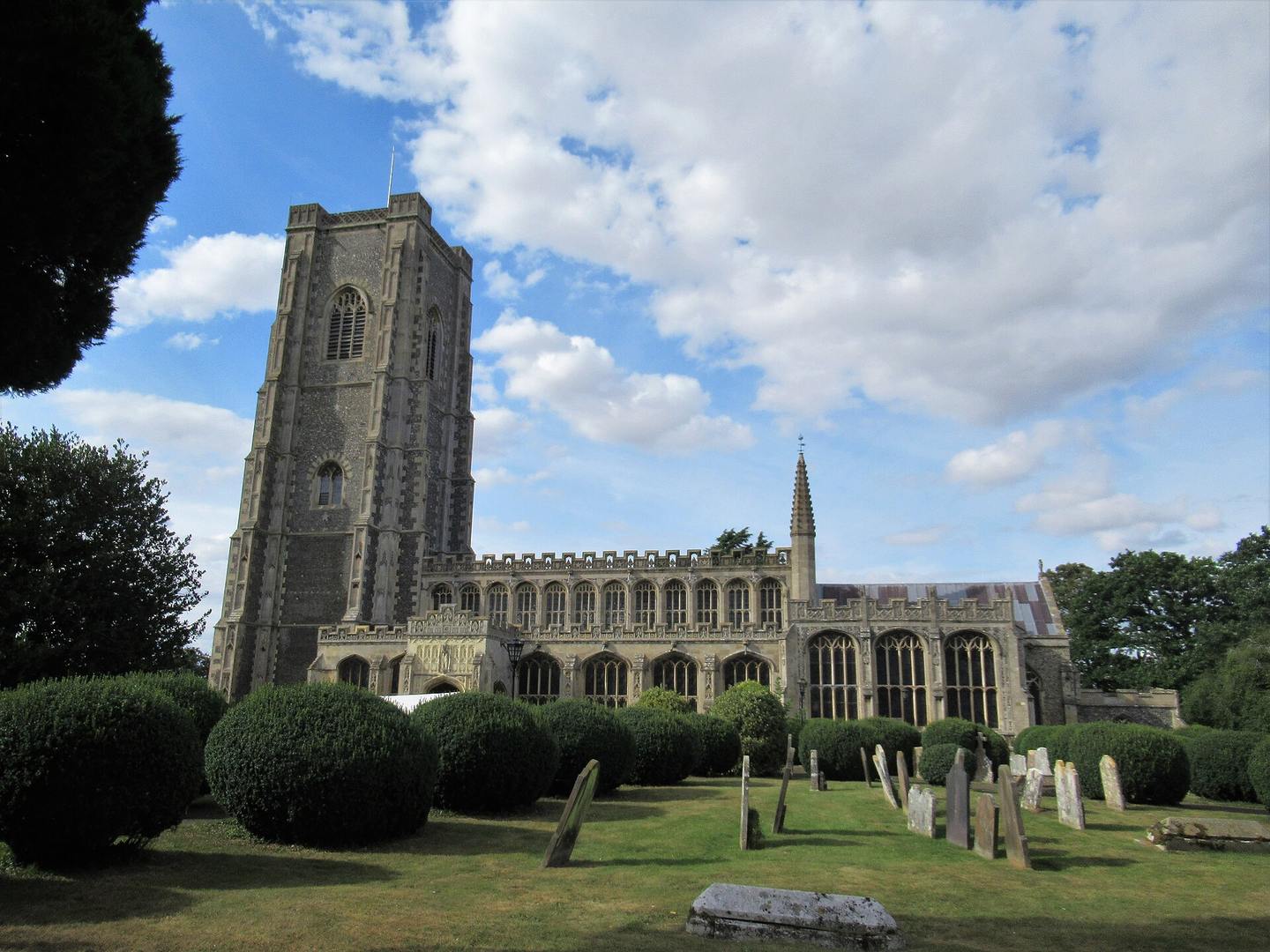 The church of St Peter and St Paul, Lavenham, with its tall flint and stone tower above the churchyard
