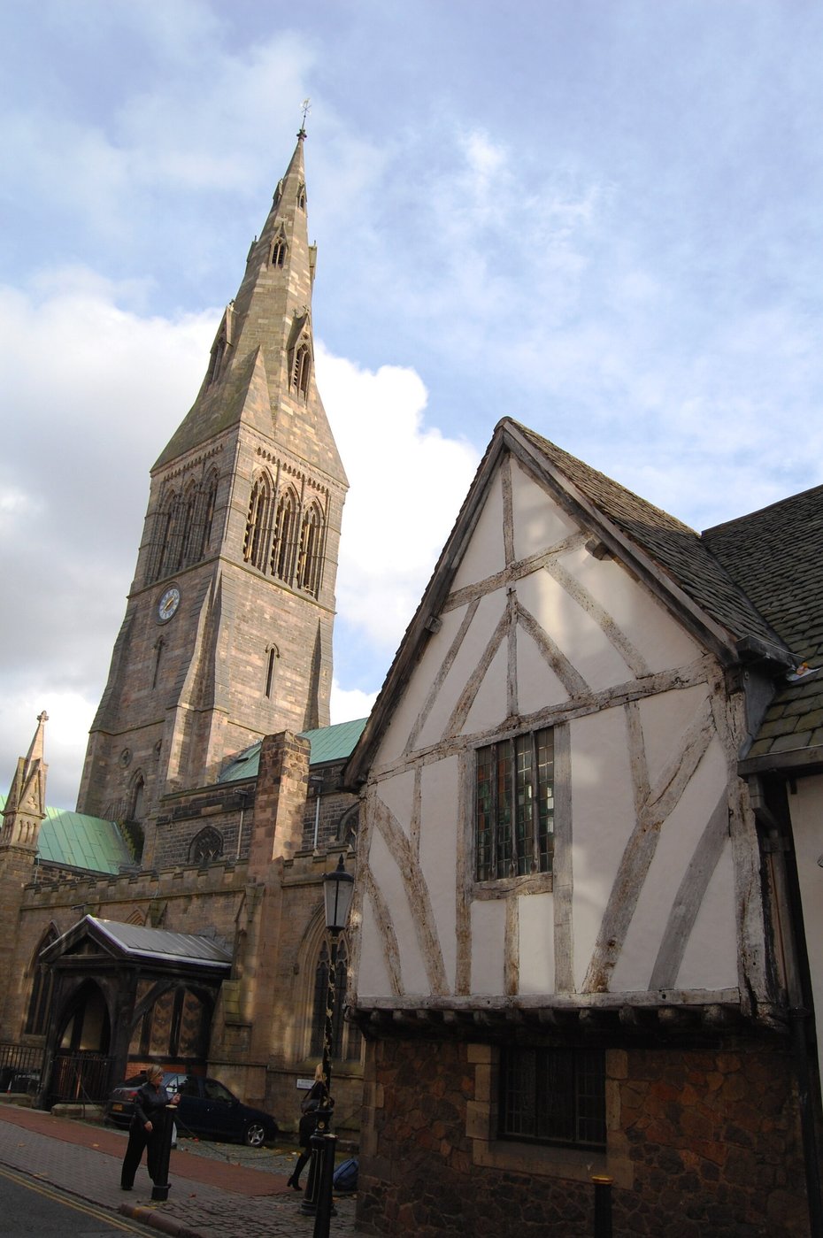 The spire of Leicester Cathedral beside the timber-framed Guildhall
