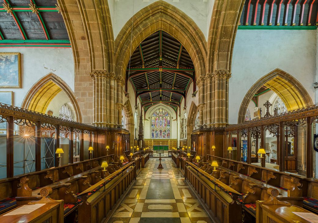 The choir of Leicester Cathedral with carved wooden stalls looking east