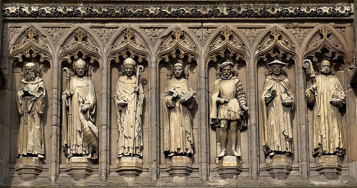 A row of carved stone statues of saints and figures in niches on the Vaughan Porch