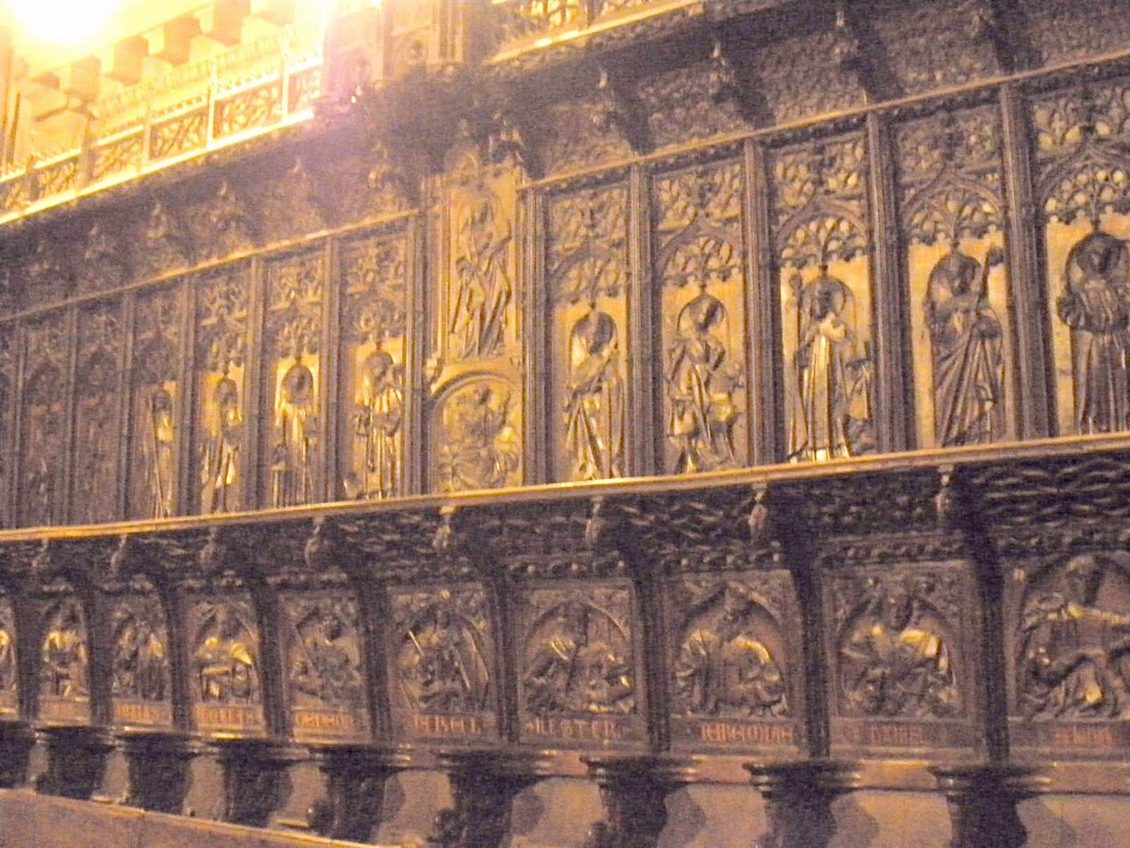Carved walnut choir stalls in León Cathedral with rows of figures of saints and prophets