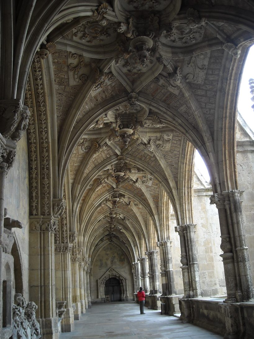 The vaulted Gothic and Renaissance walks of the cloister of León Cathedral, with sunlight on the stone floor
