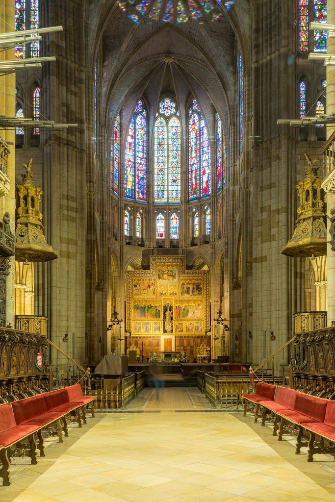 The nave of León Cathedral looking towards the high altar, with walls of stained glass above the arcades