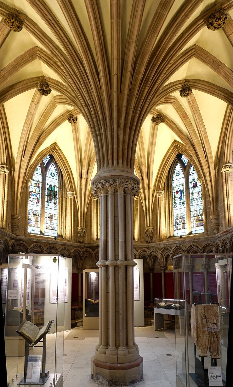 The chapter house of Lichfield Cathedral with a central pillar and display cases