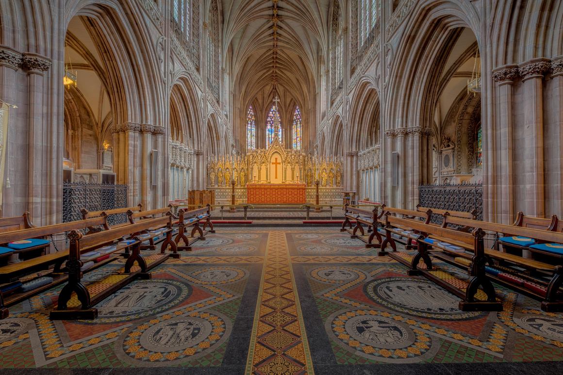 The quire of Lichfield Cathedral with its patterned tiled floor and high altar