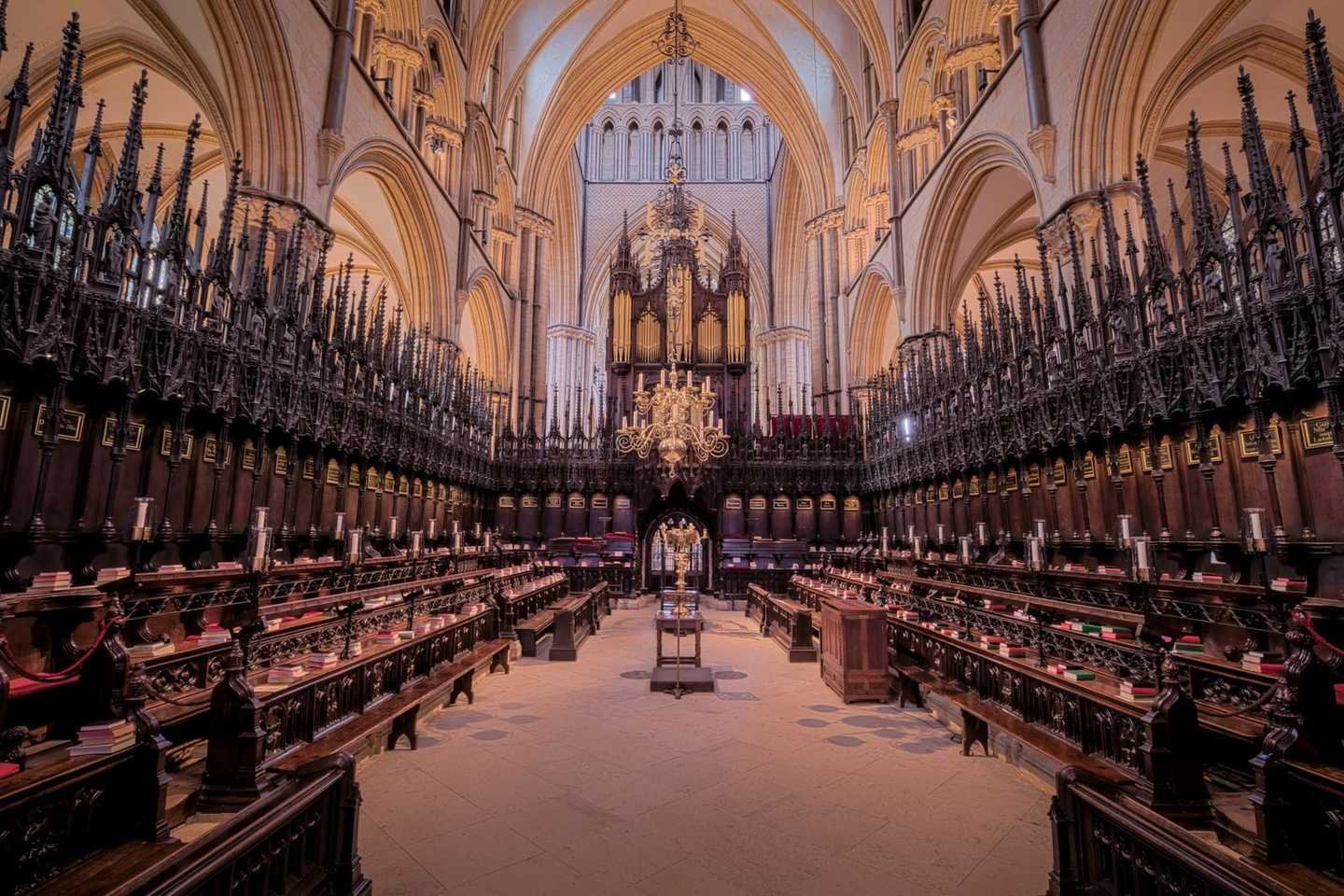 The Gothic interior of Lincoln Cathedral, richly carved stonework overhead