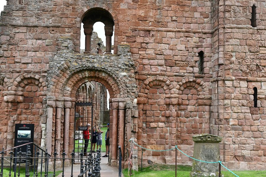 The ruined west front of Lindisfarne Priory church with its round-arched doorway