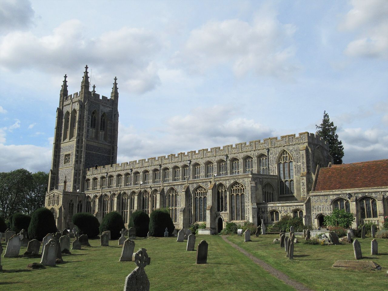 The long south side of Holy Trinity Long Melford with its rows of tall windows and flint flushwork