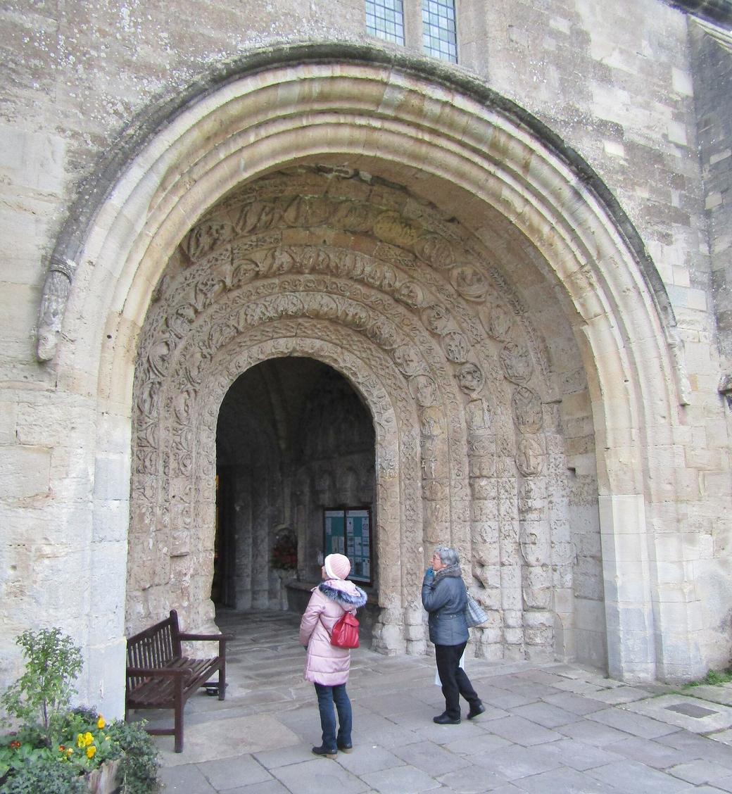 The deep round-arched Norman doorway of the south porch of Malmesbury Abbey with bands of carving