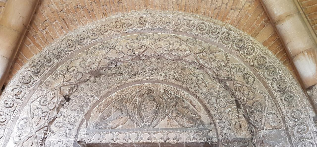 A semicircular carved stone tympanum showing Christ in Majesty supported by angels