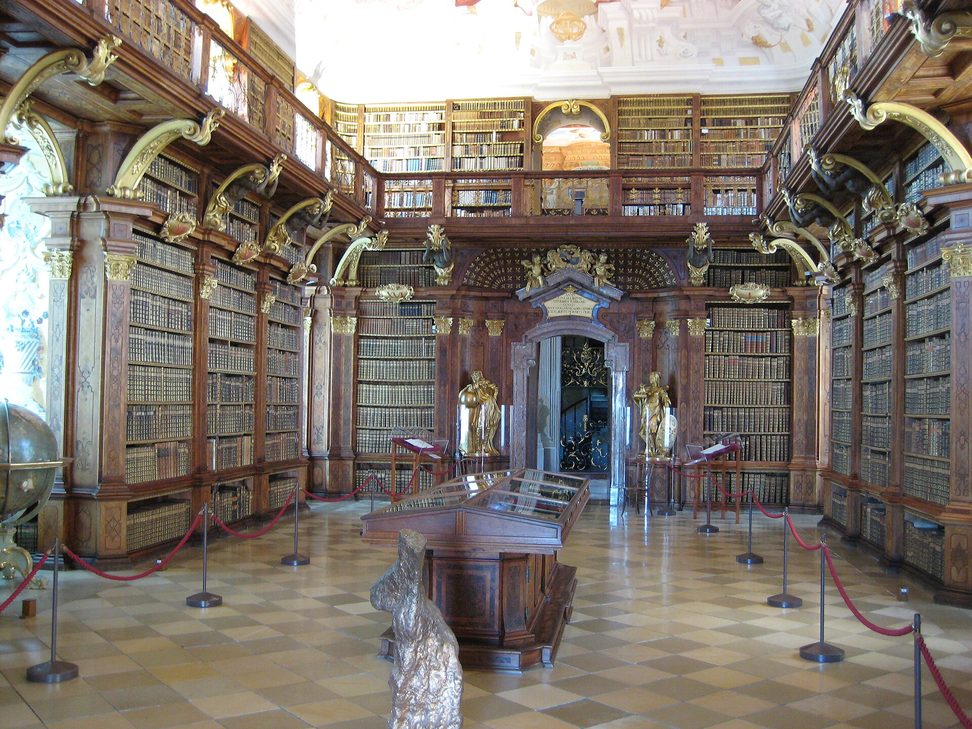 The baroque library of Melk Abbey, with gilded bookcases, a gallery and a painted ceiling