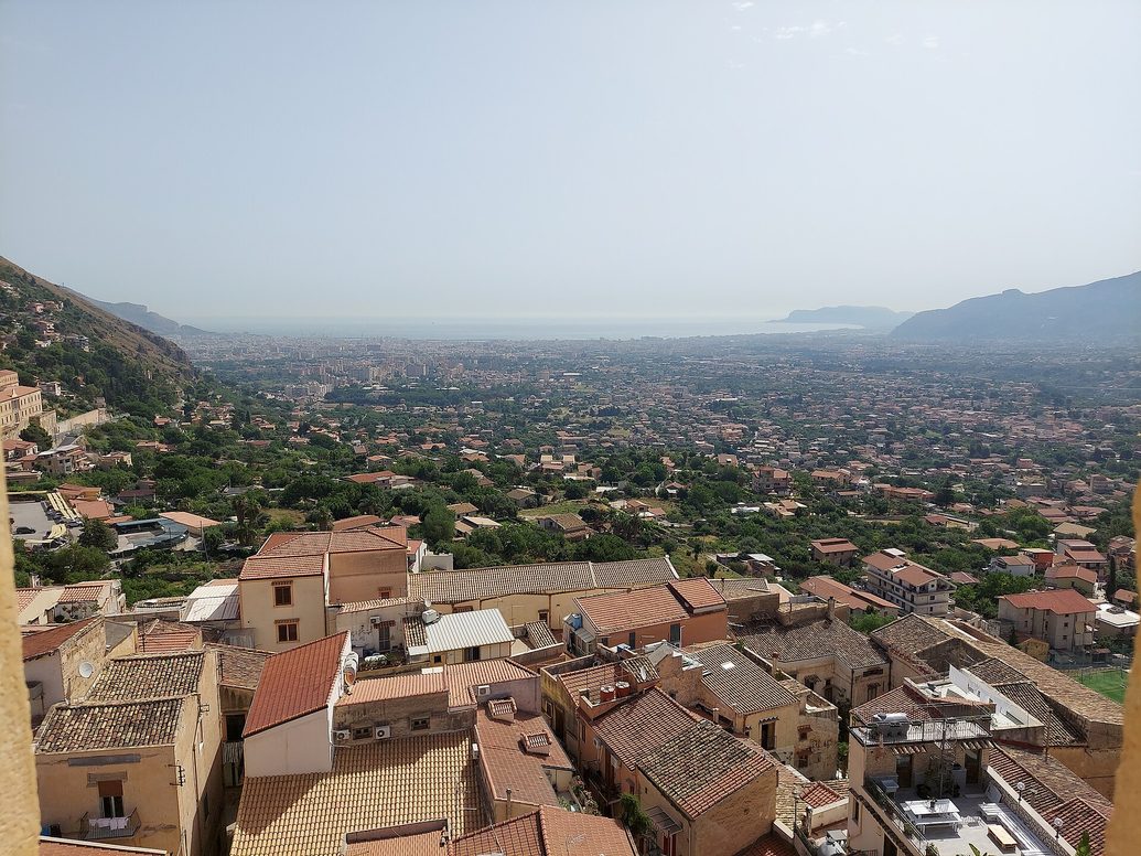 View from the roof of Monreale Cathedral over the roofs of the town and the plain down to Palermo and the sea