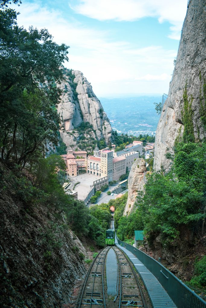 A funicular track climbing steeply up a gorge above the monastery of Montserrat