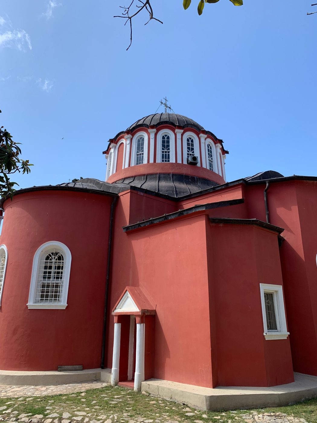 The red-painted walls and domes of a Byzantine monastery church on Mount Athos