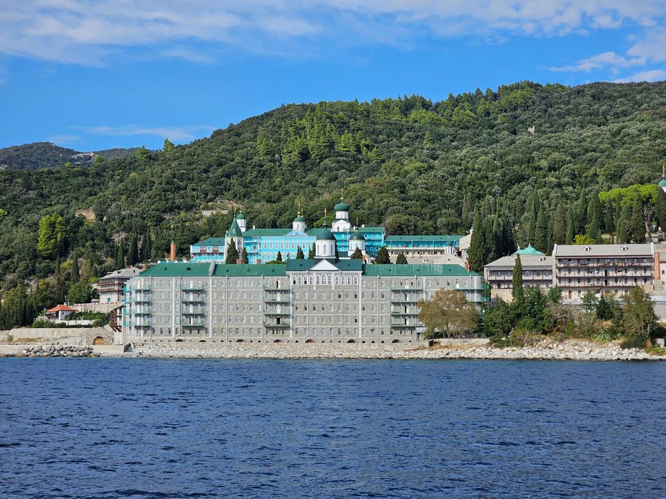 The Russian monastery of St Panteleimon on Mount Athos, with green onion domes, seen across the water