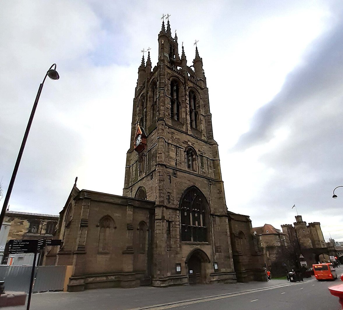 Newcastle Cathedral, its tower topped by the open stone lantern on flying buttresses, rising above the surrounding streets