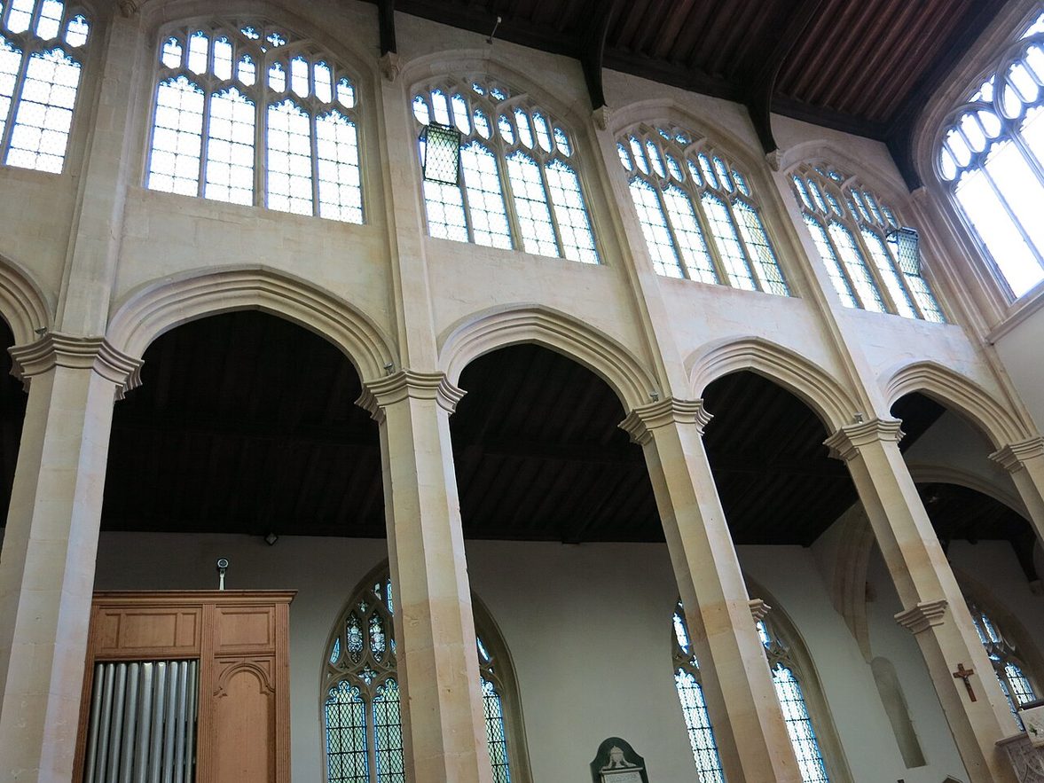 The nave of Northleach church, with tall slender arcades and a large window above the chancel arch
