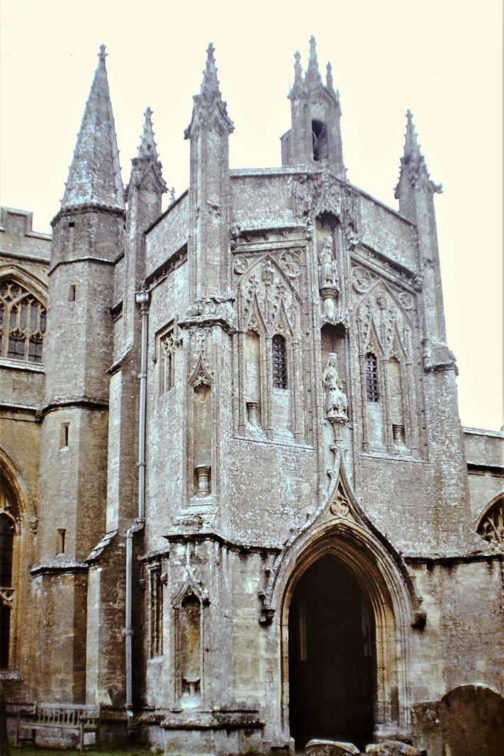 The two-storey south porch of Northleach church, with pinnacles, niches and a statue of the Virgin