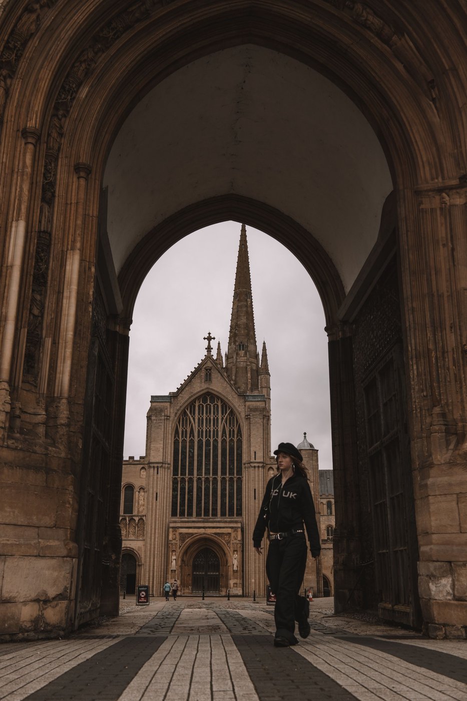 Norwich Cathedral's spire framed by an arch in the Cathedral Close