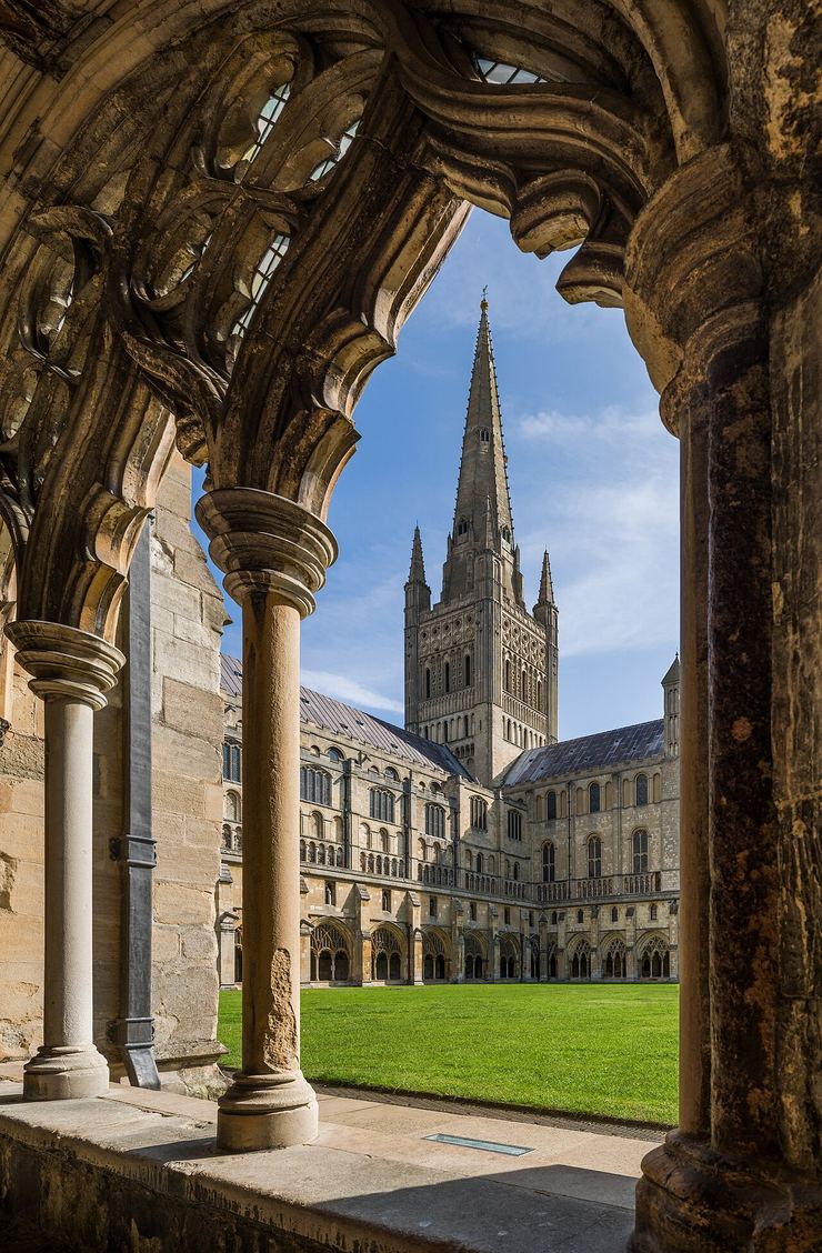The spire of Norwich Cathedral seen through the tracery of the cloister