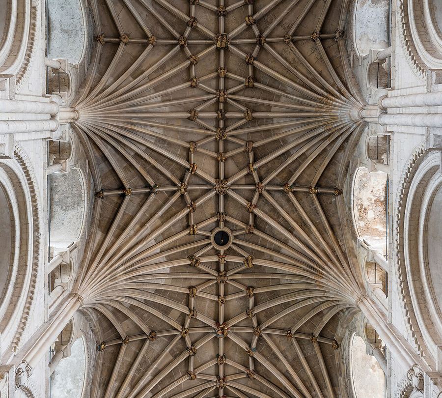 The lierne vault of the nave at Norwich Cathedral with rows of painted roof bosses