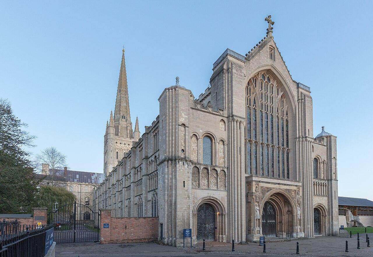 The west front of Norwich Cathedral with its great Perpendicular window and the spire behind