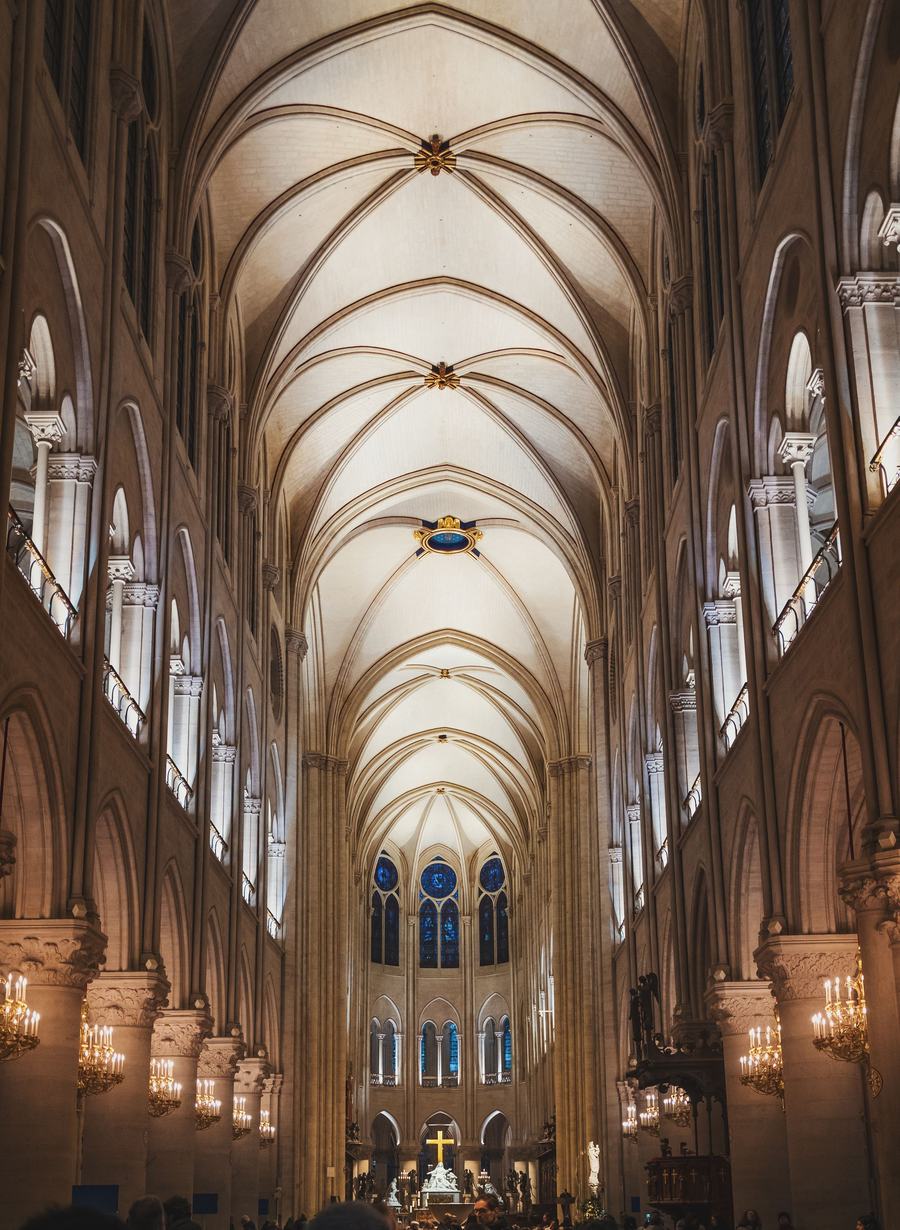 The pale restored nave of Notre-Dame de Paris looking east towards the altar