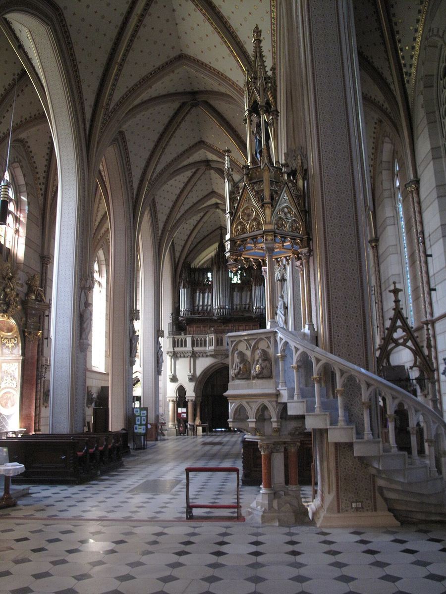 The nave of Olomouc cathedral with the tall neo-Gothic pulpit and its stair