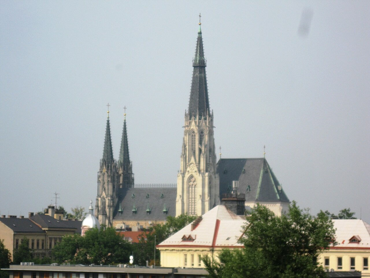 The tall south tower of Olomouc cathedral rising above the roofs of the city