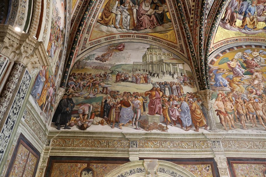 Luca Signorelli's fresco of the Preaching of the Antichrist in the San Brizio Chapel, with a crowd around the preaching figure