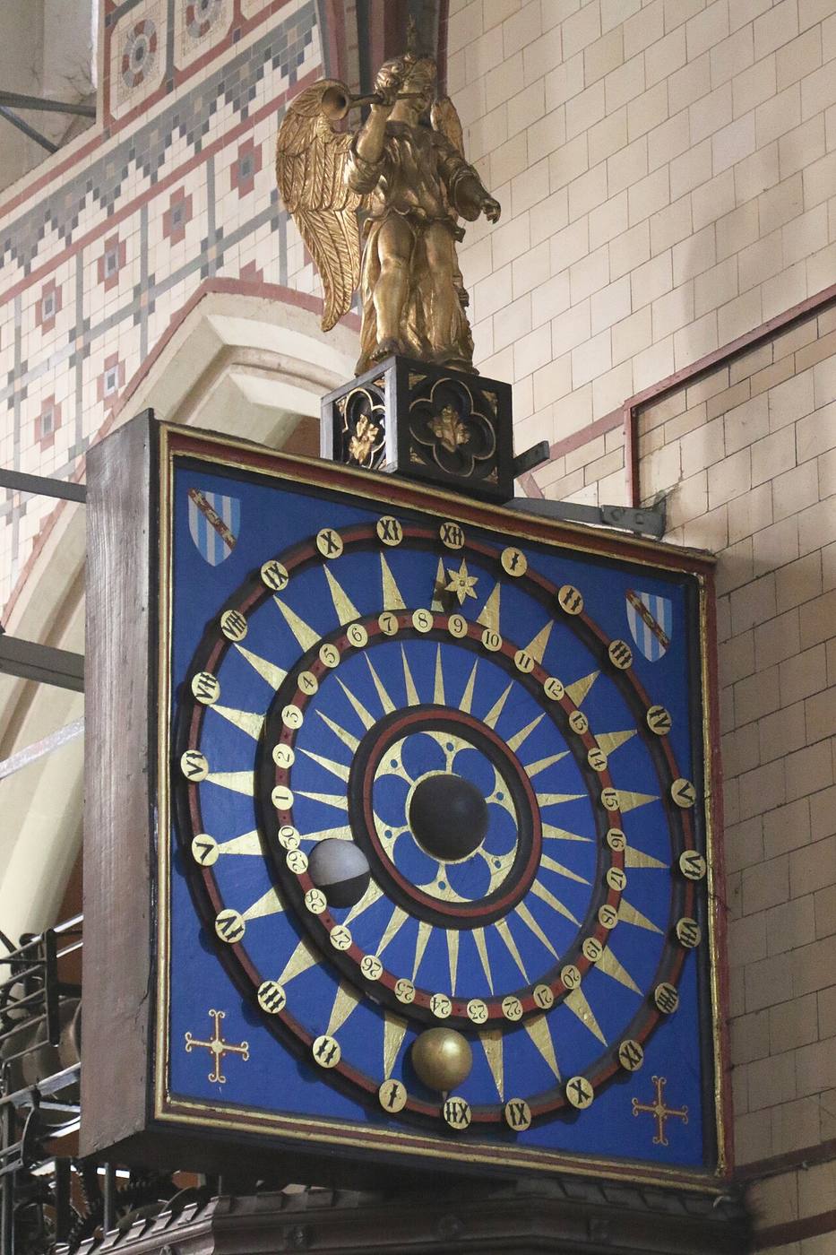 The painted medieval astronomical clock face in the south transept of St Mary's, Ottery St Mary