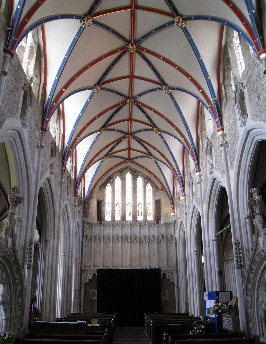 The nave of St Mary's, Ottery St Mary, looking west under a painted and vaulted ceiling