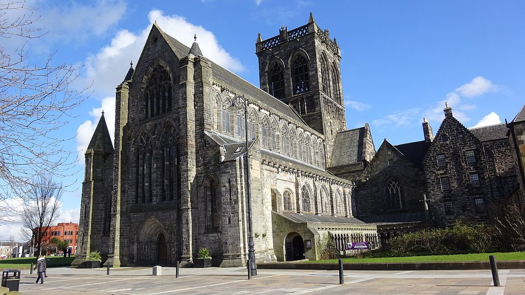 Paisley Abbey seen from the south-east, its long roofed nave, transept and central tower in grey stone