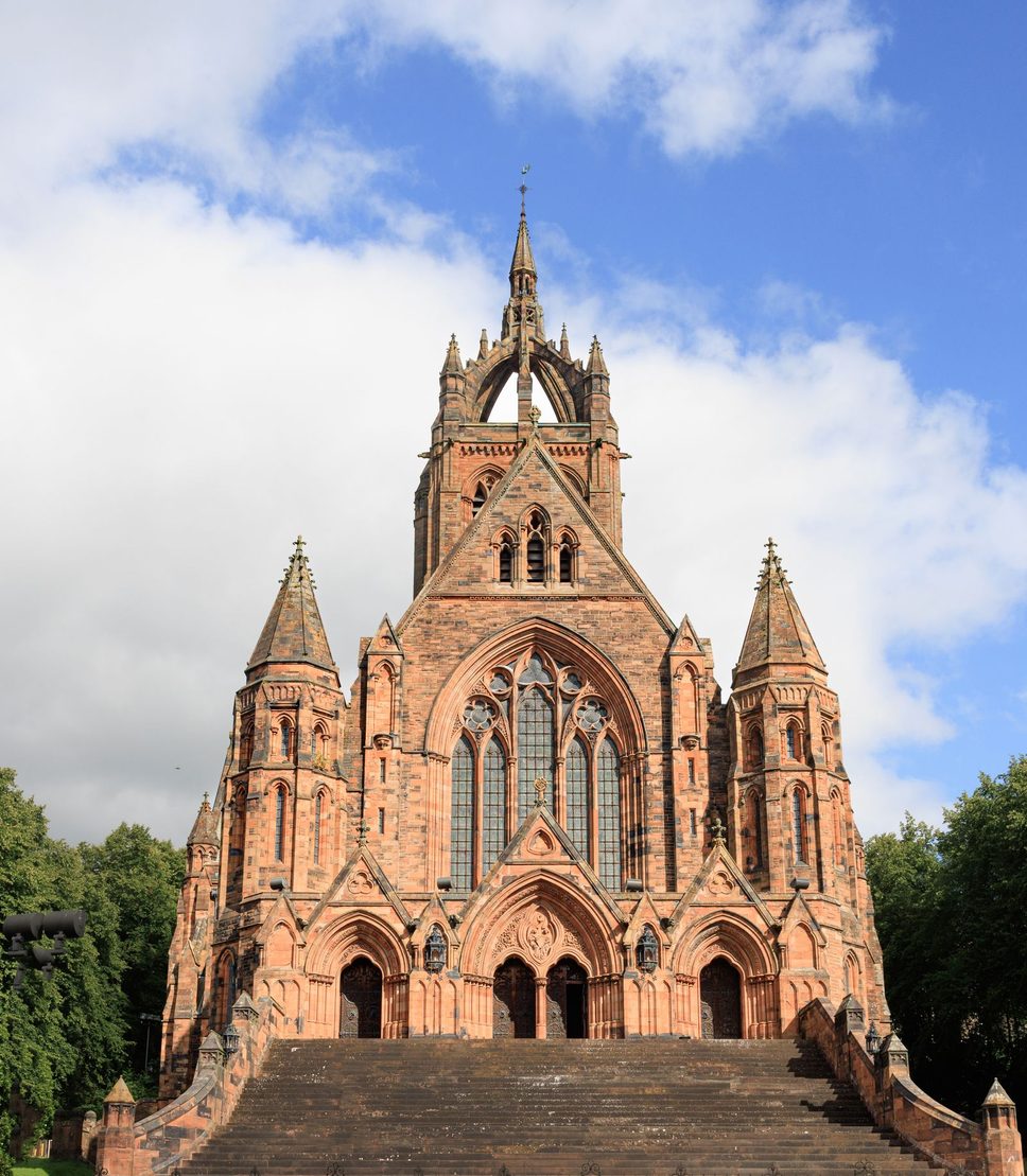 The Thomas Coats Memorial Church in Paisley, a red sandstone Gothic church with a crown spire, at the top of a flight of steps