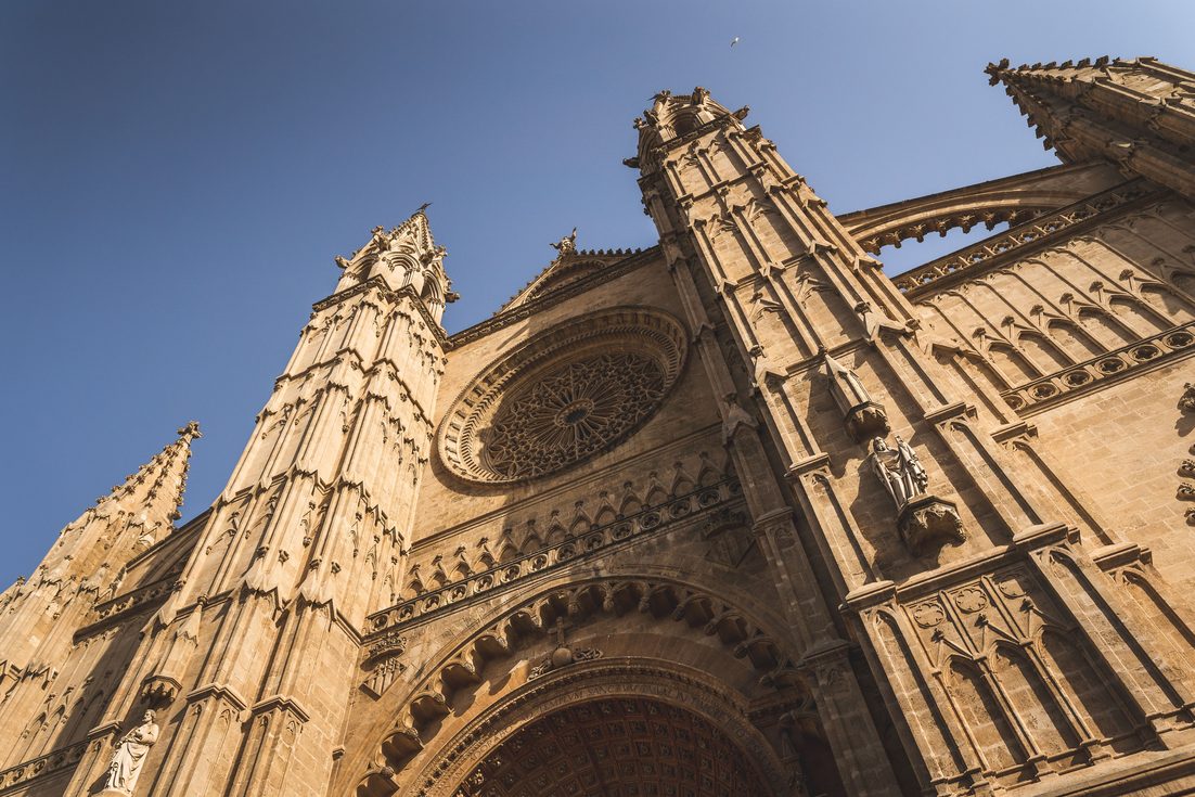 Looking up at the west front of Palma Cathedral, with its pinnacles and rose window