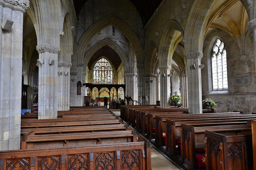 The pale stone nave of St Patrick's, Patrington, with clustered piers and pointed arches looking east