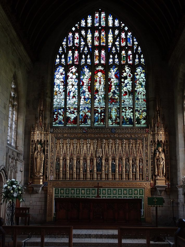 The east end of St Patrick's, Patrington, with a gilded reredos beneath the large stained glass east window