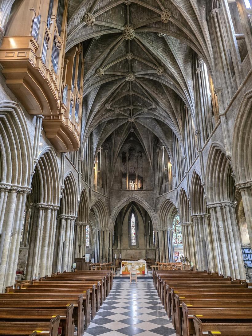 The interior of Pershore Abbey looking east, with tall Gothic arcades and a rib vault