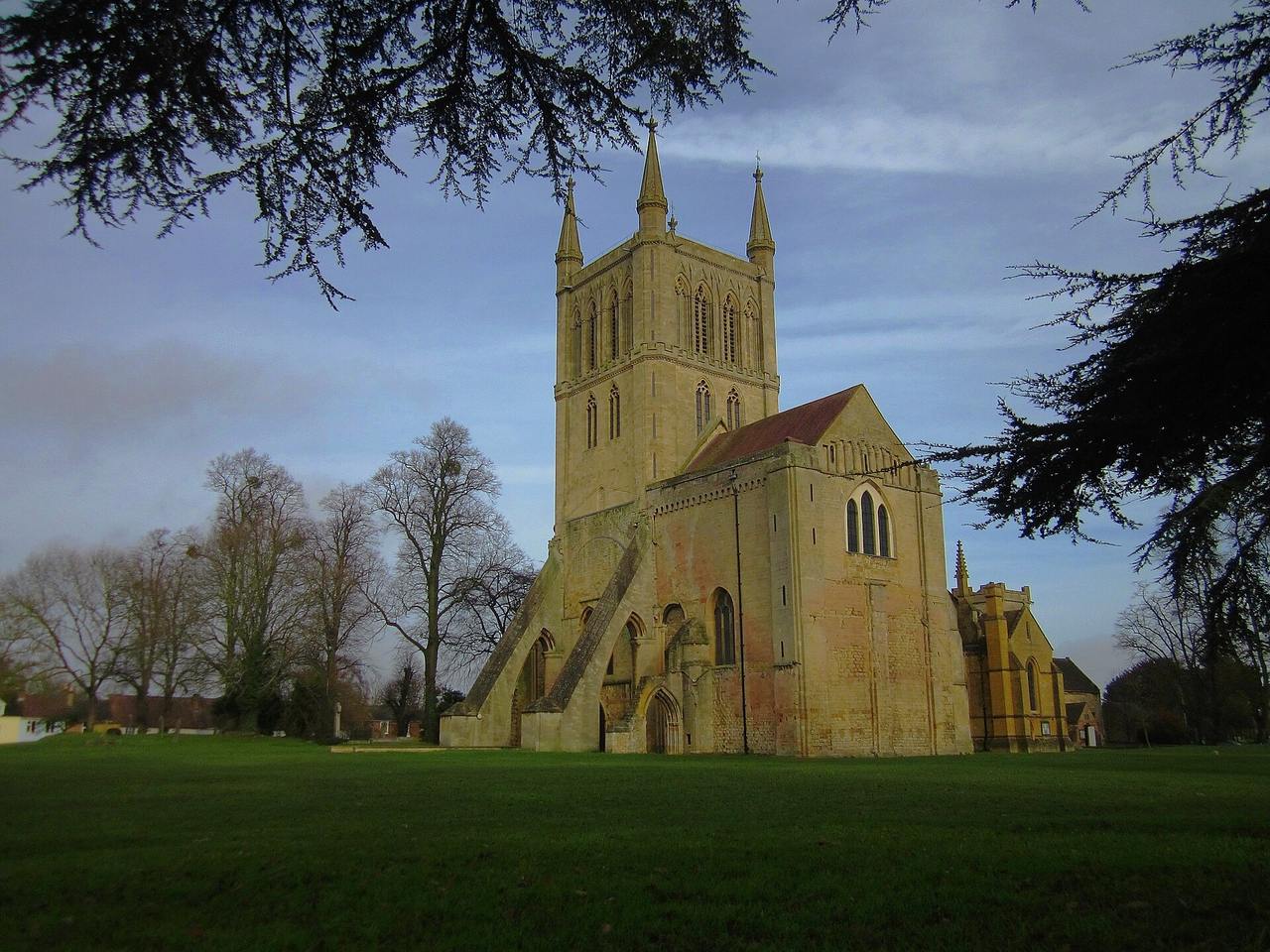 Pershore Abbey's tall pinnacled tower and the surviving east end seen across the park