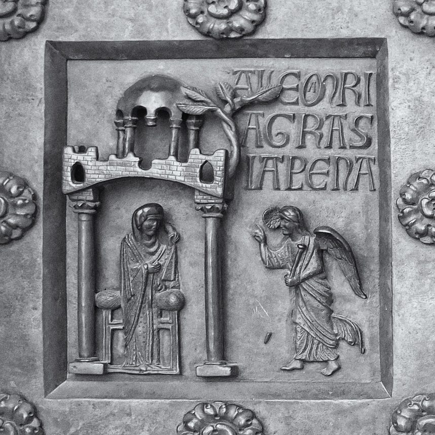 A bronze relief of the Annunciation, with the angel and the Virgin under an arch, from the Porta di San Ranieri