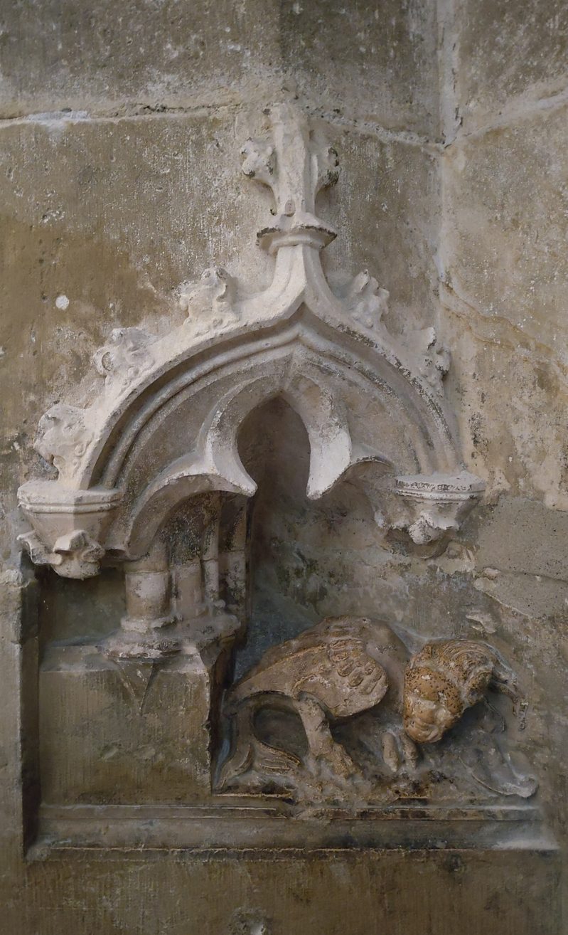 A small medieval stone figure of the Devil carved in a niche beside the west portal of Regensburg Cathedral