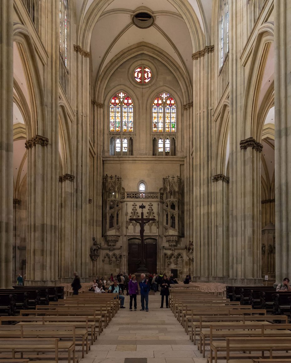 The tall Gothic nave of Regensburg Cathedral looking east towards the choir, with stained-glass windows in the clerestory