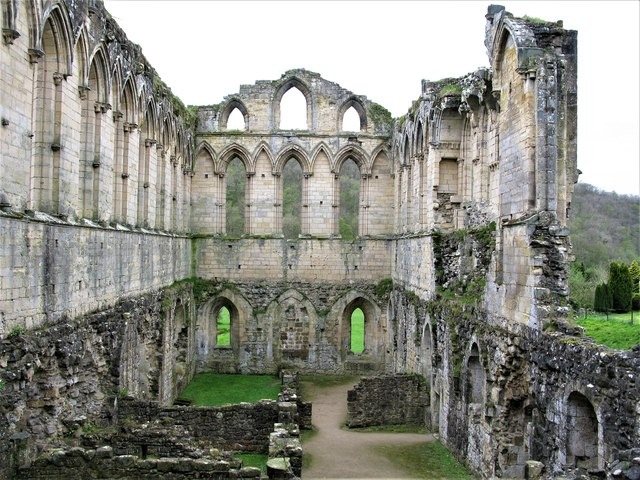 The tall ruined wall of the refectory at Rievaulx Abbey with its lancet windows