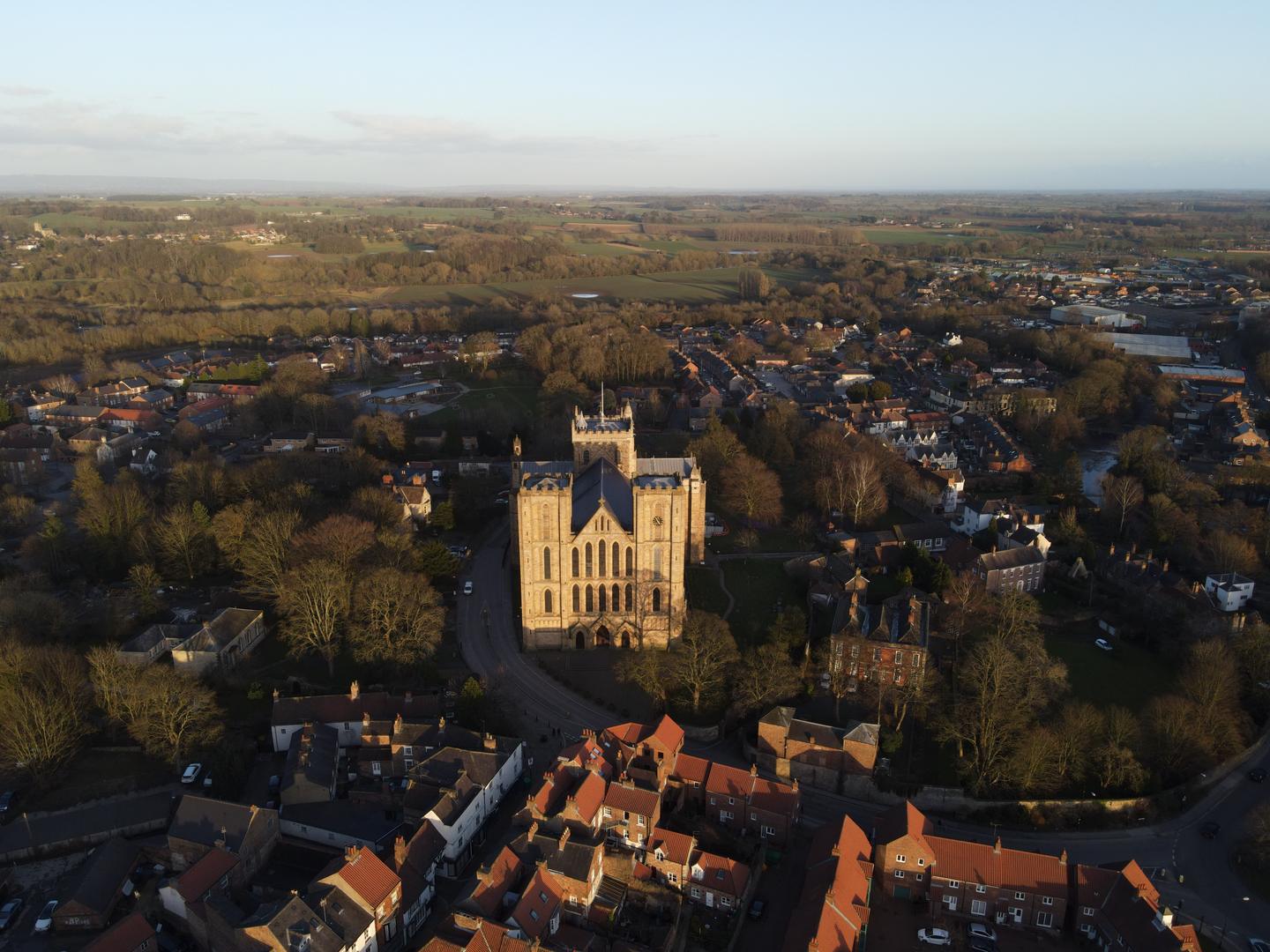 Aerial view of Ripon Cathedral's twin west towers with the town and countryside beyond